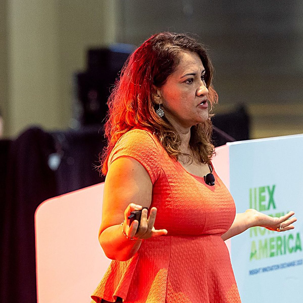 Marta Villanueva mid-presentation on the IIEX North America stage.